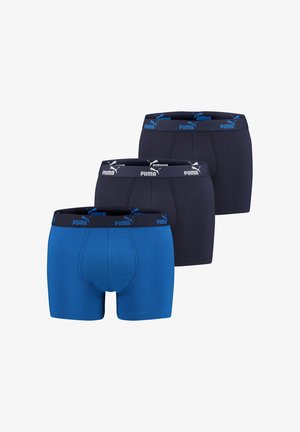 Puma boxers in a pack of three: one blue and two dark blue, featuring elastic waistbands with blue Puma branding and a smooth texture.