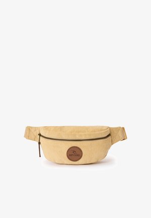 Riñonera beige de pana con compartimento principal con cremallera y correa ajustable, con un parche circular marrón con el logo de Rip Curl.