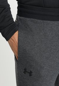 Under Armour Teplákové kalhoty - black