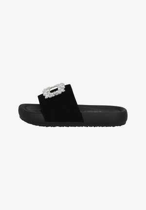 Black slide sandal featuring a wide strap in soft material, adorned with a rectangular rhinestone embellishment on the vamp, textured sole.