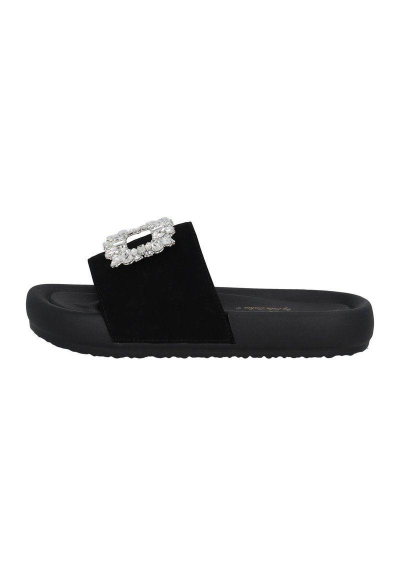 Black slide sandal featuring a wide strap in soft material, adorned with a rectangular rhinestone embellishment on the vamp, textured sole.