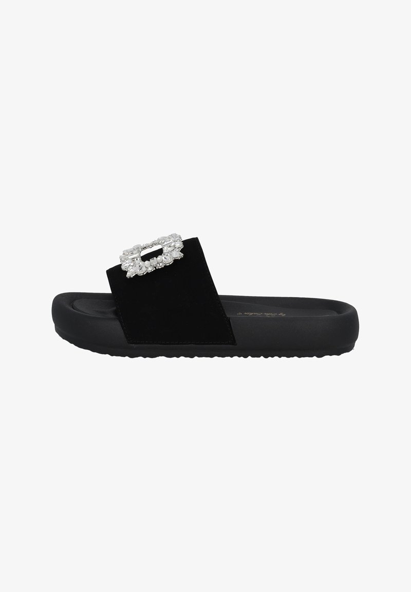Black slide sandal featuring a wide strap in soft material, adorned with a rectangular rhinestone embellishment on the vamp, textured sole.