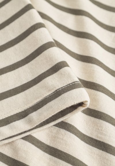 Light beige fabric with dark olive green horizontal stripes, featuring a soft texture and a rolled hem detail.