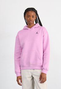 Light pink hoodie made of soft fabric. Features a front kangaroo pocket and a black Jordan logo on the left chest. Ribbed cuffs and hem.