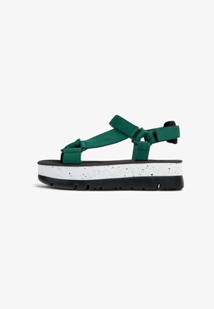 Green platform sandals with adjustable straps, featuring a white speckled midsole and black outsole. Textured straps enhance grip.