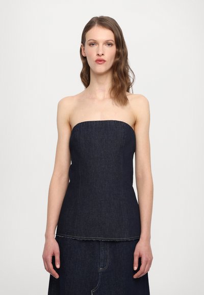 Denim strapless top, mørk tvæt, struktureret pasform med vandret søm ved kanten, parret med en matchende denimnederdel.