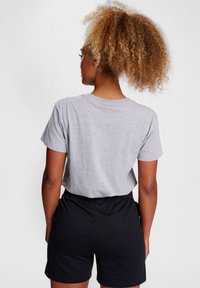 Gray cotton t-shirt with short sleeves and round neckline, paired with black elastic-waist shorts, viewed from the back.