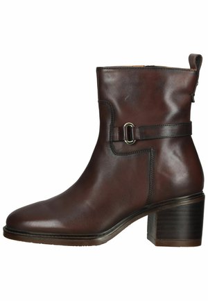 Brown leather ankle boot with a rounded toe, side zipper, buckle accent, and a stacked heel. Smooth texture and minimal stitching details.
