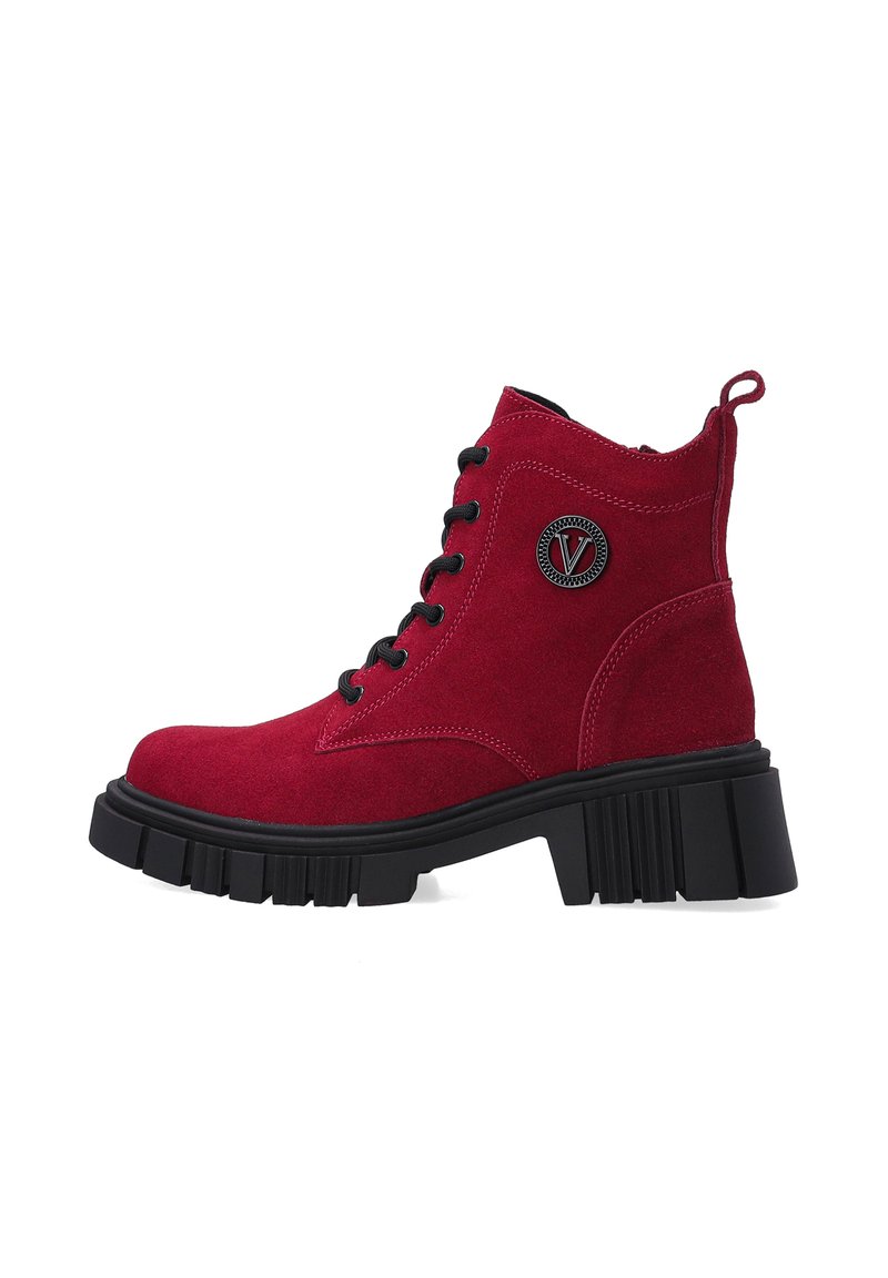 Red suede ankle boots with a chunky black sole. Features black laces, a rear pull tab, and a circular logo on the side.