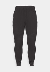 Zwarte sportbroek met een elastische tailleband, taps toelopende pijpen en gebogen naden. Gemaakt van zachte, gestructureerde stof voor comfort.