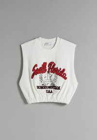 Vit ärmlös croppad sweatshirt med röd och svart text "South Florida" samt grafisk emblem på framsidan, elastisk fåll och rund hals.