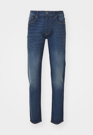 Tume sinine pesu denim teksad, mis on sirge jala disainiga, esiküljel taskud ja tagasihoidlik pleekimine. Allservas sirge äär.