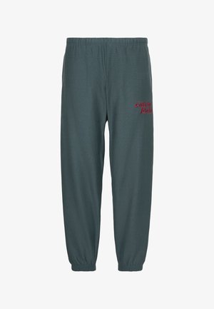 Pantalon de jogging vert foncé avec taille et poignets élastiques, comportant un petit logo rouge "calvin klein" sur la partie supérieure de la cuisse gauche.