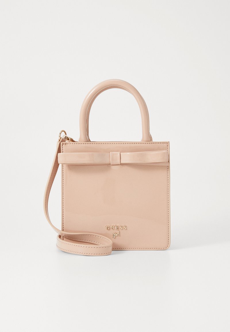 Small blush pink handbag made of patent leather. Features a top handle, detachable shoulder strap, and a bow accent on front.