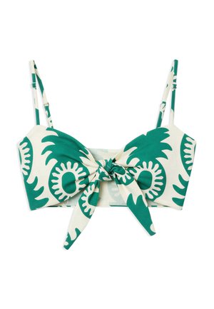 White crop top with green abstract floral patterns, adjustable shoulder straps, and a front tie knot detail.