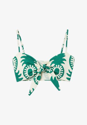 White crop top with green abstract floral patterns, adjustable shoulder straps, and a front tie knot detail.