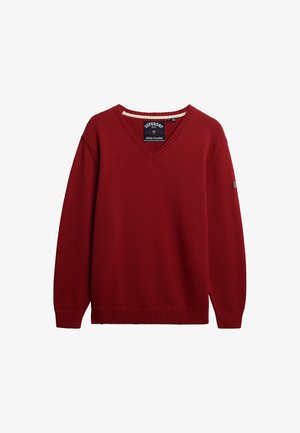 Rode gebreide V-hals trui met ribbels aan de manchetten en onderkant, lange mouwen en een klein logo-opdruk op de linkermouw.