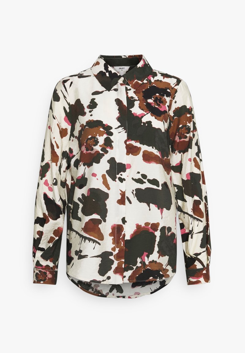 Chemise à manches longues avec un motif floral abstrait marron, noir et rose sur fond blanc.