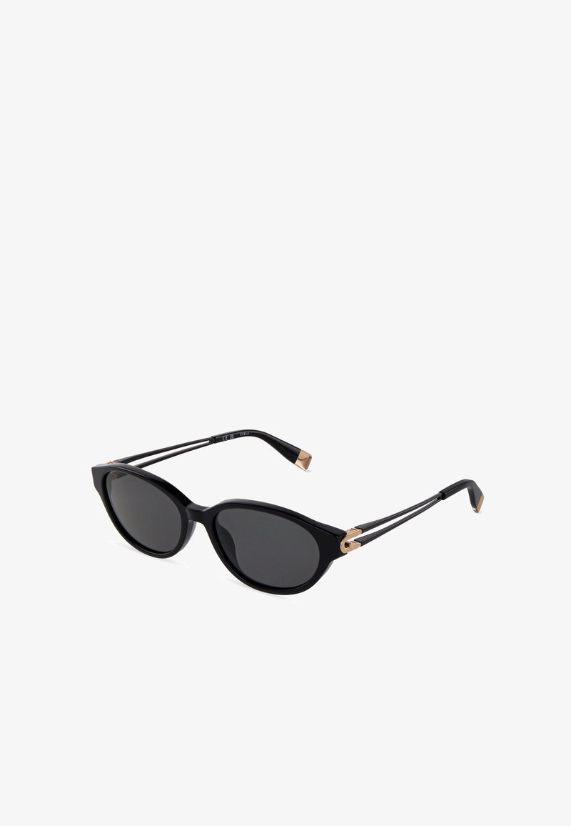 Lunettes de soleil noires en forme d’œil de chat avec verres foncés et fines branches noires présentant des accents dorés sur les charnières et les extrémités.