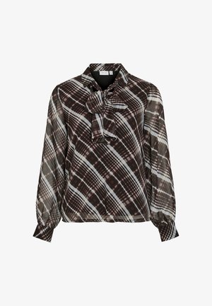 Brun och krämrutigt blus med en fluga vid halsen, gjord av ett lätt, halvgennomsiktigt tyg. Har långa, något puffiga ärmar.