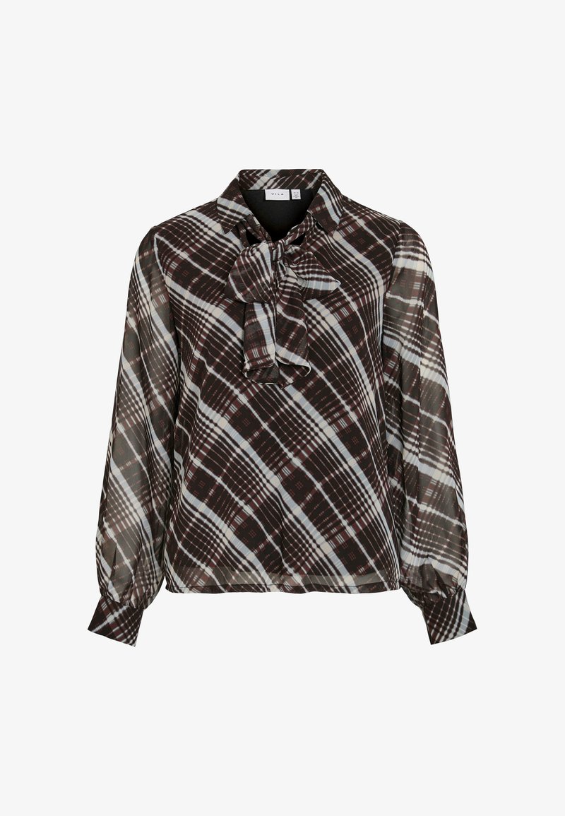 Brun och krämrutigt blus med en fluga vid halsen, gjord av ett lätt, halvgennomsiktigt tyg. Har långa, något puffiga ärmar.