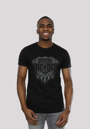 Schwarzes Baumwoll-T-Shirt mit einem grafischen Druck von "AC/DC Black Ice" mit Blitz und dekorativen Elementen in Grau. Kurze Ärmel, Rundhals.