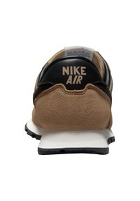 Brun ruskind og sort læder Nike Air sneakers hæl med hvid mellemsål og sort ydersål, vist fra bagsiden.