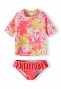 T-shirt de surf tie-dye rose et jaune à manches courtes au-dessus d'un bas de bikini corail à volants, fabriqué en tissu extensible pour le confort et l'ajustement.
