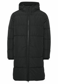 Sort pufferjakke med hætte, udstyret med en frontlynlås og ribbede manchetter. Designet med et quiltet mønster til isolering.