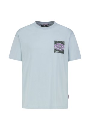 Light blue short-sleeve T-shirt with "Memories by the Sea" text and a purple palm tree graphic on the left chest.