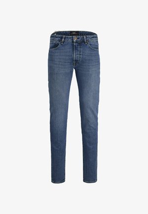 Blå denim jeans med slim fit, fem lommer og glidelås. Har en subtil slitt tekstur og detalj med en brun metallknapp.