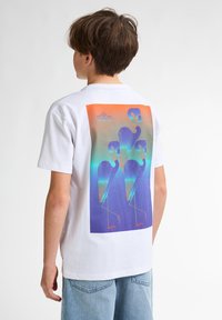 Hvid bomulds t-shirt med et farverigt grafik på ryggen. Designet inkluderer blå abstrakte figurer på en orange og blå gradient baggrund.