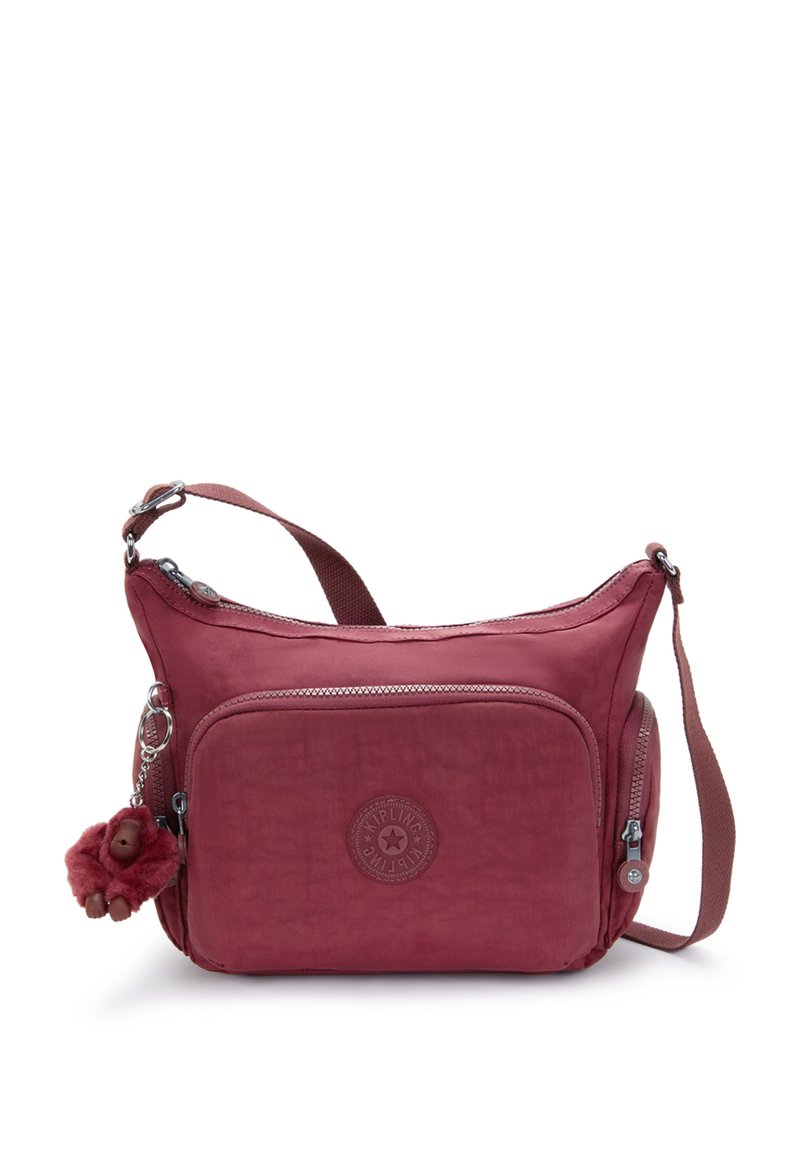 Kompakt bordeaux röd crossbody-väska med fram- och sidofickor med dragkedja, justerbar rem och en liten mjuk apnyckelring fäst.