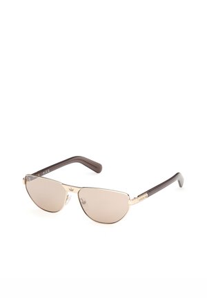 Okulary przeciwsłoneczne aviator z złotą ramą, brązowymi szkłami z przyciemnieniem oraz ciemnobrązowymi zausznikami z logo Adidas na zausznikach.