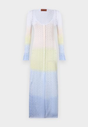 Kötött hosszú kardigán, amely lágy pasztell színek gradiensével rendelkezik: fehér, sárga és világoskék, cseppmintázattal és gombos elülső záródással.