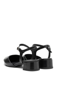 Dei tacchi in pelle nera con punta tonda, cinturino alla caviglia e tacco a blocco. Superficie liscia con finitura lucida e dettagli hardware minimali.