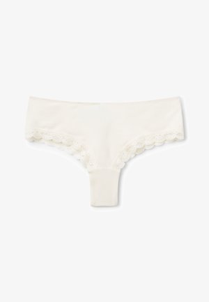 Tanga color crema con ribetes de encaje, confeccionado en una mezcla suave de algodón, con bordes en forma de ondas y un diseño liso y sin costuras.