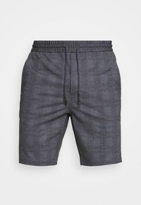 Harmaat ruudulliset shortsit, joissa on joustava vyötärönauha, kiristysnauha ja teksturoitu kangas. Mallissa on tummemman ja vaaleamman sävyn ruutukuosi.