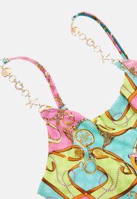 Colorful, patterned fabric top featuring pink, green, and blue hues, with golden hardware accents and decorative chain details on straps.