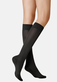 Schwarze, kniehohe Socken aus glattem, elastischem Material mit einem festen Bund oben und strukturierten, rutschfesten Sohlen.