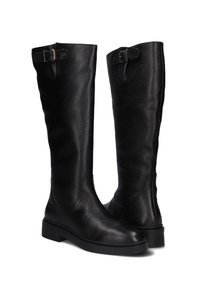 Black textured knee-high leather boots with low heels and adjustable buckle straps near the top.