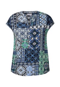 Blusa a maniche corte caratterizzata da un design a patchwork con intricati motivi blu, verdi e neri. Il materiale sembra leggero con una vestibilità comoda.