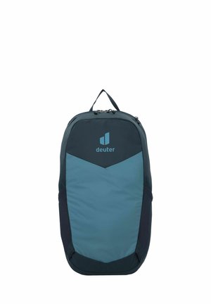 Zaino in tessuto blu navy e verde teal, caratterizzato da un design triangolare con dettagli in rete, maniglia superiore, doppie cerniere e un logo sul davanti.