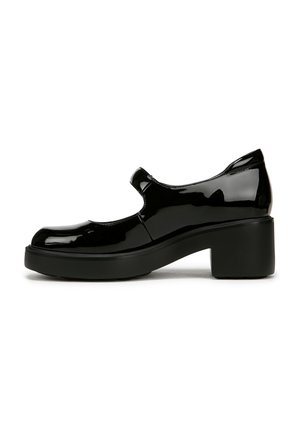 Chaussure Mary Jane en cuir verni noir avec un bout rond, une bride à la cheville et un talon épais. Présente une texture lisse et un design minimaliste.