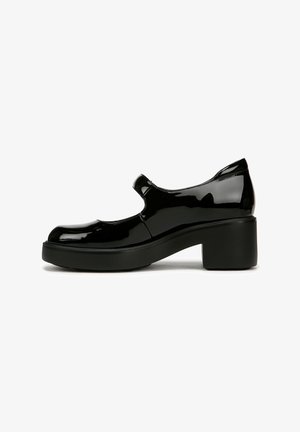 Scarpa Mary Jane in vernice nera con punta tonda, cinturino alla caviglia e tacco largo. Presenta una superficie liscia e un design minimalista.