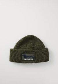 Dark green ribbed knit beanie with folded brim and rectangular patch labeled "Tommy Jeans, N.Y." on a white background.