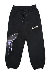 Pantaloni sportivi neri con vita e polsini elasticizzati, cordino, grafica a goccia della mano sulla gamba sinistra e testo "Disclaimer" bianco sulla coscia destra.