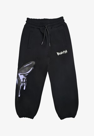 Pantaloni sportivi neri con vita e polsini elasticizzati, cordino, grafica a goccia della mano sulla gamba sinistra e testo "Disclaimer" bianco sulla coscia destra.