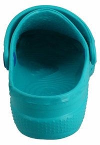 Turquoise clogs with a textured inner surface, rounded back, and two blue buttons on the side. Smooth, lightweight material.