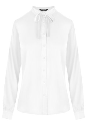 Biała bluzka z zapięciem na guziki z przodu, długimi rękawami i kokardą przy kołnierzyku. Gładki materiał, dopasowany krój oraz marszczone mankiety.
